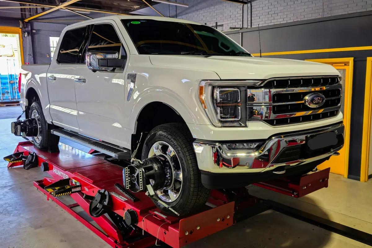 Ford F-150 on the hoist for wheel alignment at Tyre Doctors