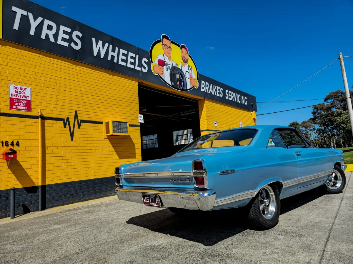 Tyre Doctors shopfront on Ferntree Gully Road, Knoxfield, with a classic car parked out front